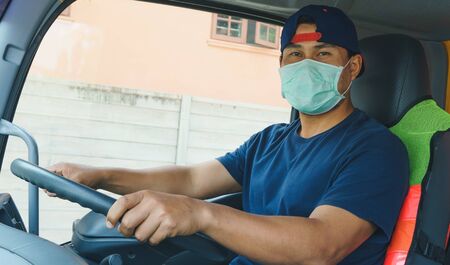 Close-up photos of Asian truck drivers wearing masks to protect against dust and the spread of the...