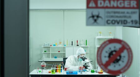 Researchers are inventing and testing antiretroviral drugs. In a safe high level laboratory. After that, the virus was examined by a microscope.の写真素材