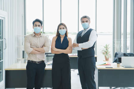 portrait Multi-ethnic male and female business group Everyone is wearing a medical mask. Smile and...