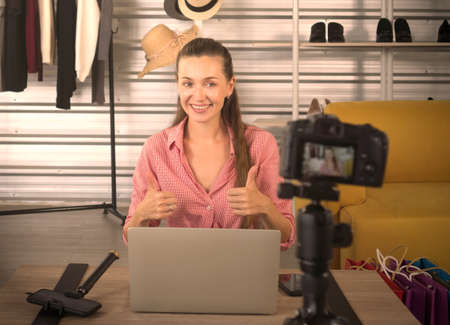 Attractive young caucasian woman smile and greets people following social media.