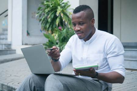 portrait happy African American young man smiling confident optimistic sitting Communication Video...