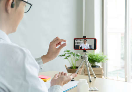Asian senior man smiling online consultation physician specialist about health distance from home....