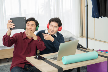 Two young man friends are excited while watching TV online on digital tablet Stay at home Have fun....