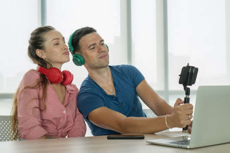 Caucasian couple selfie sharing video vlog content online on social media having fun Greeting Follower. man and woman streaming Digital marketing cyberspace creative on webcam -  concept.の写真素材