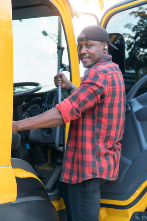 truck driver smiling confident in insurance cargo lorry In long transportation and delivery business. young African-American man training driving commercial driver license at truck driving school.の写真素材