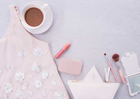 Fashion concept, Trendy fashion Handbag, shirts and cosmetic, Woman Accessories on gray background with copy space, minimal style, flat lay.の写真素材