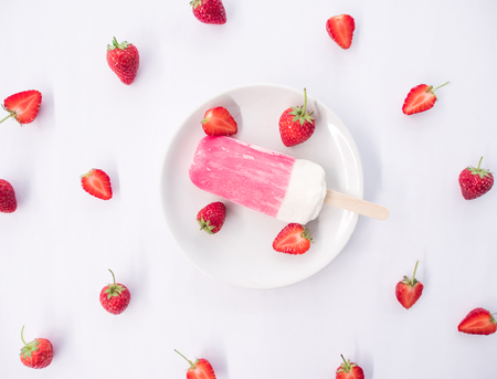 flat lay, fruit concept, strawberry ice cream in white plate on white background.の写真素材