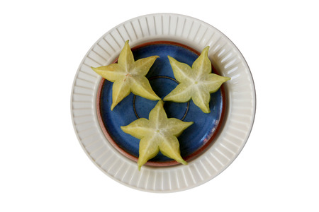 Starfruits on blue and white platesの写真素材