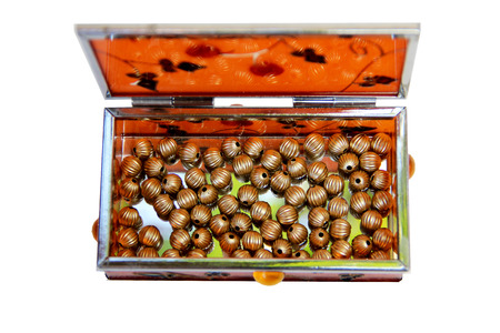 Orange Miror Box filled with golden beadsの写真素材