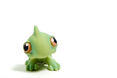 cute green dinosaur with big eyes, isolated on whiteの写真素材