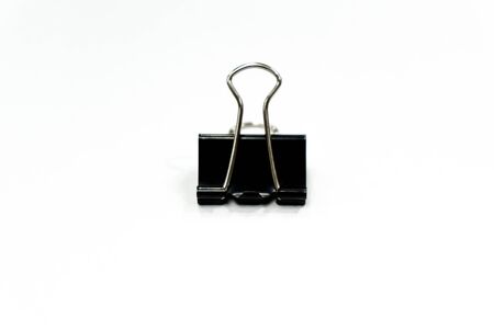 Black binder clip on whiteの写真素材