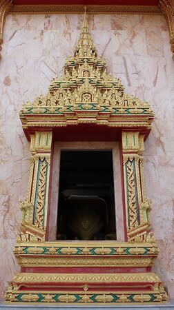 thai art window on the wall of thai churchの写真素材