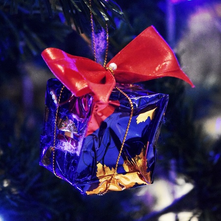 Tiny present box decorated on Christmas treeの写真素材