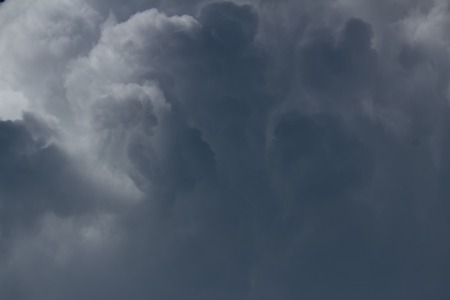 white cumulus clouds on dark blue sky before the storm