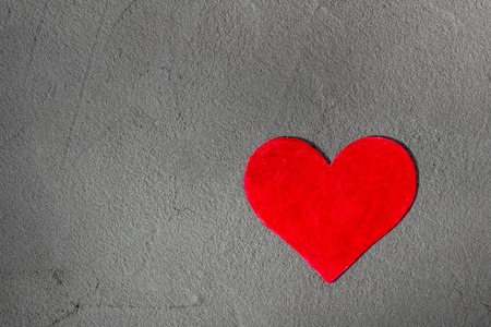 Red paper heart on gray textural background with copy space Happy Valentine backgroundの写真素材