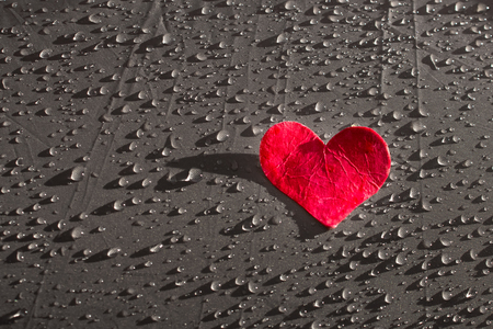 Valentines Day background with red heart on fabric with raindrops copy spaceの写真素材