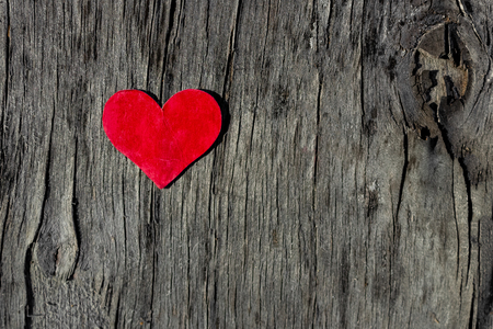 red heart lies on a old wooden backgroundの写真素材
