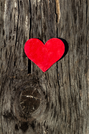 red heart lies on wooden backgroundの写真素材
