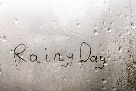 The word RAINY DAY written on the wet glass rainの写真素材