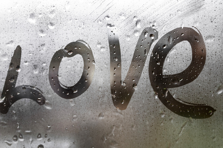 inscription love on the wet glass rain greeting card for Valentines day holidayの写真素材