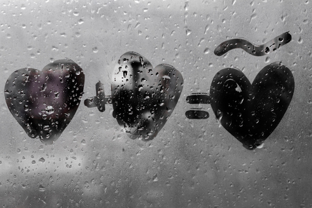 two hearts with plus sing and equality sign on window in Rainy weather , valentine's day , day valentineの写真素材