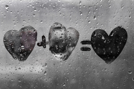 two hearts with plus sing and equality sign on window in Rainy weather , valentine's day , day valentineの写真素材