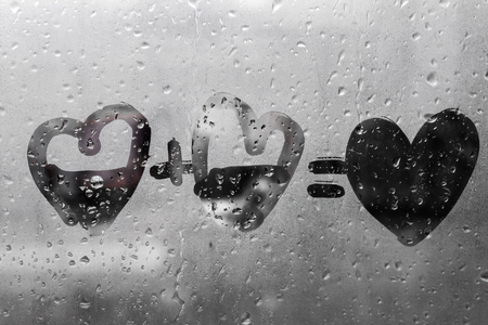 two hearts with plus sing and equality sign on window in Rainy weather , valentine's day , day valentineの写真素材