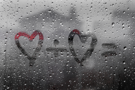two hearts with plus sing and equality sign on window in Rainy weather , valentine's dayの写真素材