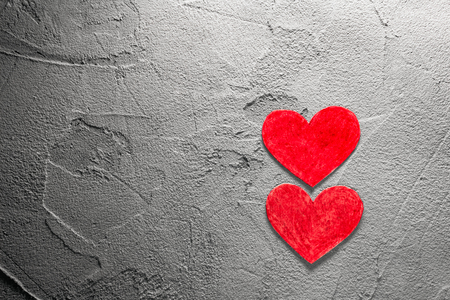 Two Red paper hearts on gray wall with copy space Happy Valentine backgroundの写真素材