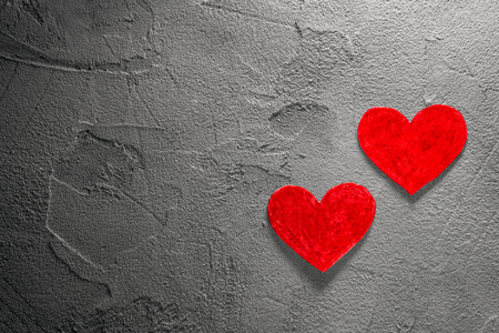 two Red paper hearts on gray wallの写真素材