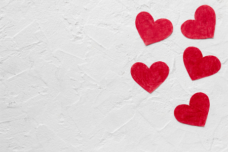 five Red paper hearts on White wall with copy space Happy Valentine backgroundの写真素材