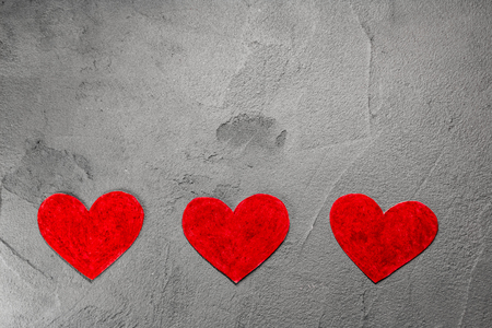 Red paper hearts on gray wall with copy spaceの写真素材