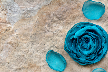 Handmade blue bud on background of stone texture with petals, spa concept, Copyspaceの写真素材