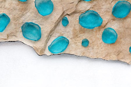 Blue petals arranged in a row on a stone textured background with white empty space for textの写真素材