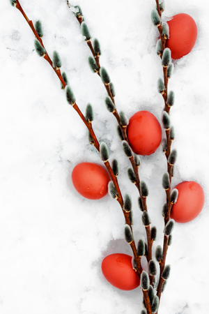 bouquet of willow branches and Easter painted red eggs, top viewの写真素材