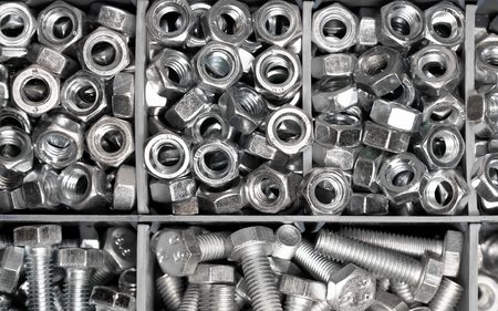 new bolts and nuts sorted in a container shot closeup, background, mechanic work conceptの写真素材