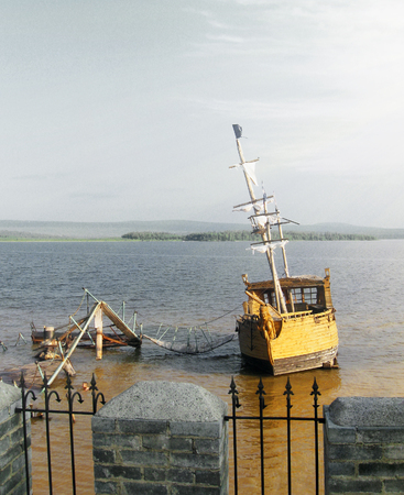old wooden ship with a mast anchored in the sunの写真素材