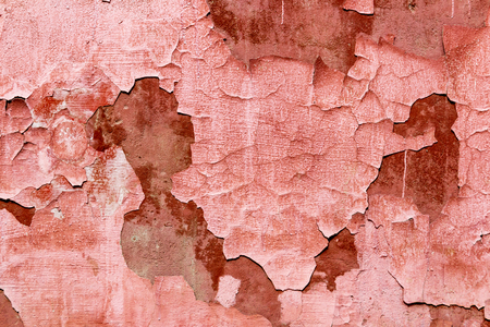 Closeup of old peeling coral painted texture of wallの写真素材