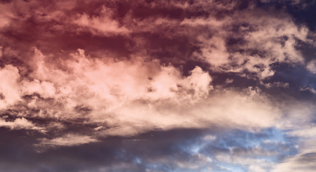 Colorful cumulus clouds on the sky. Color toned image in pinkの写真素材