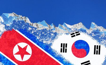 The flags of Korean People Democratic Republic and Republic of Korea is painted on piece of ice in the form of an arctic iceberg against a blue sky.の写真素材