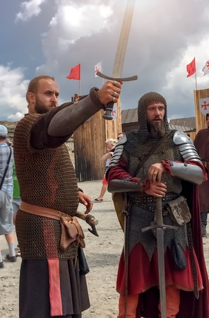 Sudak, Russia - August 16, 2015: two brutal men with beards in the costumes of medieval knights in...