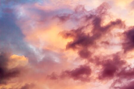 Colorful cumulus clouds on the sky. Color toned image in pinkの写真素材