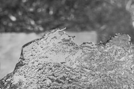 Ice against the gray background. A winter concept and minimalizm concept. A structure of the frozen water in black and white. abstract natural backgroundの写真素材
