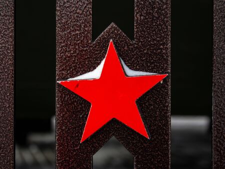 The red five-pointed metal star is a symbol of the Soviet Union and the Soviet Army, a close-up...