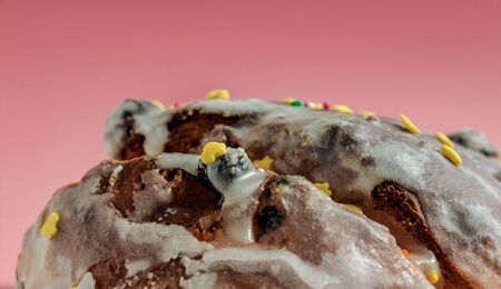 Sugar colored confetti lies on a white icing rustic cake, texture of sugar icing on a cupcake surface close-up. Happy birthday conceptの写真素材