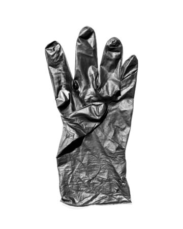 New black latex glove with thumb folded isolated on a white background. New disposable rubber gloves. The concept of successful work of a chef of a surgeon or cleaningの写真素材