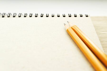 two pencils on the empty page of a reporters book journal with springs in the sun Mock-up Copy spaceの写真素材
