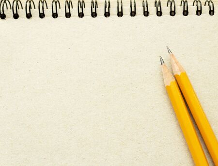 two pencils on the empty page of a reporters book journal with springs in the sun Mock-up Copy spaceの写真素材