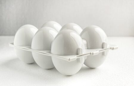 white plastic tray for six reusable eggs, close up. Environmental reusable concept, Happy Easter...