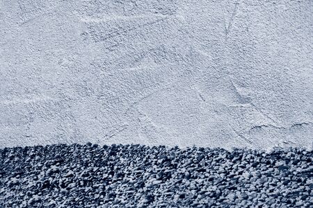 texture of classic blue sand plaster with sea pebbles, concept of summer background, vacation and recreation, page spread, background with copy space, trend colorの写真素材